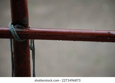 String tied around a rusty piple after the rain