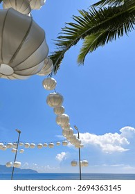 String of White Lanterns Against Clear Blue Sky