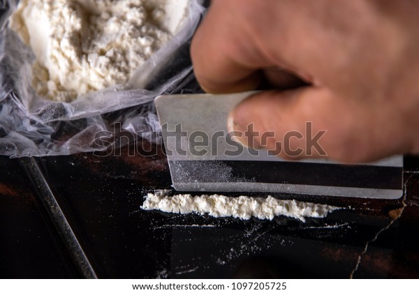 strip of cocaine on a background of packing with a\
drug and a plastic card