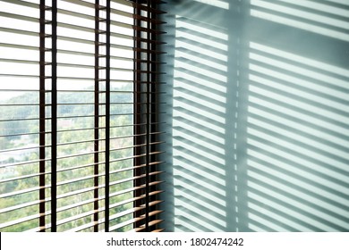 Strip of light and shadow from window shutter, abstract background for interior design