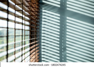Strip of light and shadow from window shutter, abstract background for interior design