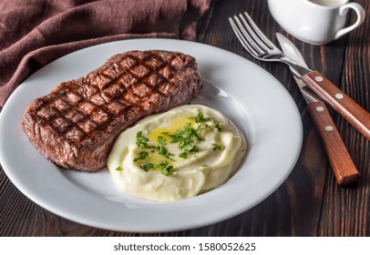 Strip Steak With Celery Puree On White Plate