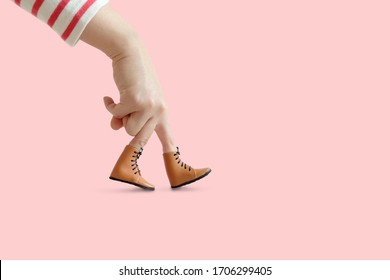 Stripe shirt Hand finger walking with shoe isolated on pastel background, Minimal hand finger travel concept, Exercise health care concept.