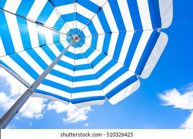 Striped Beach Umbrella On The Beach.