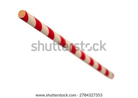 striped biodegradable paper drinking straw with red and white diagonal stripes isolated white background, single use eco friendly utensil, angle view soft focus