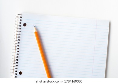 Striped blank notebook with pencil.  Spiral notepad and orange crayon. - Powered by Shutterstock