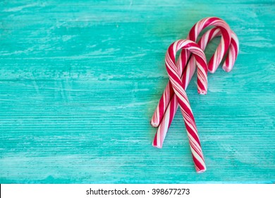 striped candies on turquoise background Stock Photo