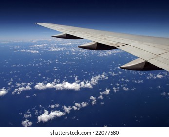 Striped Cloud pattern with Airplane wing over ocean
