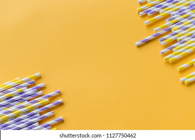 Striped Drink Straws Of Different Colors In Row Isolated On Yellow Background. Minimalism Concept. Pop Art Style. Flat Lay With Straws Used For Drinking Water Or Soft Drinks. Selective Focus. Copy