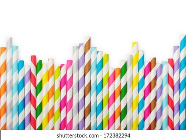 Striped drink straws of different colors in row isolated on white background