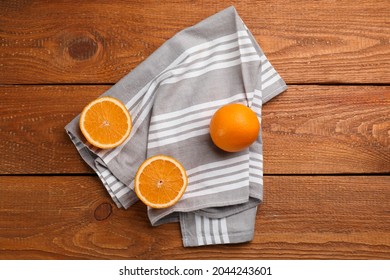 Striped Kitchen Towel And Oranges On Wooden Table, Flat Lay