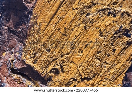 Striped limonite rock surface as a background. Close-up of limonite (laɪmənaɪt) iron ore.