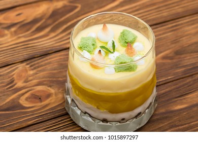 Striped Orange Jelly Glasses With Souffle And Cream Decorated By Mint