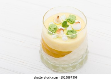 Striped Orange Jelly Glasses With Souffle And Cream Decorated By Mint