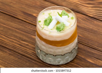 Striped Orange Jelly Glasses With Souffle And Cream Decorated By Mint