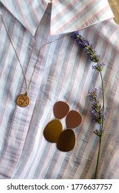 Striped Pastel Blouse, Gold Necklace With Vintage Pendant, Earrings And Lavender Flower. Top View.