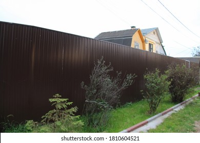 striped shadow from fence in village. Wooden fence. Separate and protect private property. Outside built new wooden fence construction surrounding dutch garden. Aluminum Fence With Decorative Elements