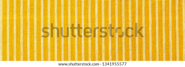 Striped yellow white fabric texture. Linen cloth\
surface as Easter Yellow cloth background. Living yellow linen\
fashion , banner