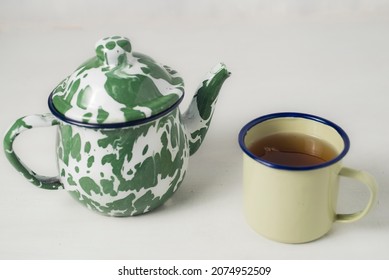 Stripes Vitreous Enamel Teapot And Glass Isolated On White Background