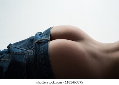 Stripped model. Female with sexy ass posing. Sexy Back And Big Butt. Woman body stripper. Huge buttocks. Jeans and denim concept