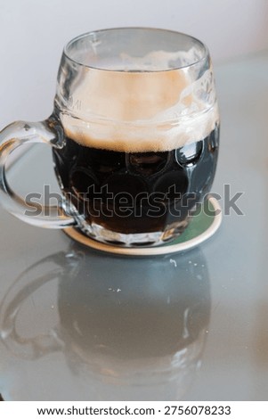Strippeddown setting emphasizes intricate features of chilled stout beer