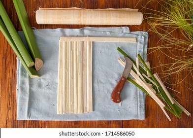 Strips obtained from the stem of papyrus plant with a typical knife and a finished rolled up sheets