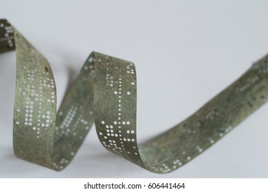 Strips Of Old Punched Tape On White Surface