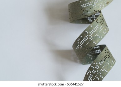 Strips Of Old Punched Tape On White Surface