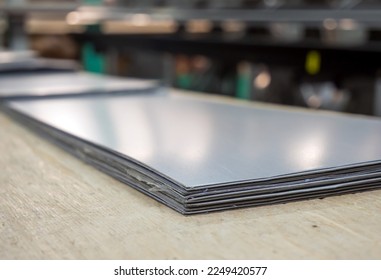 Strips of thin metal on the working table of the bender of the ebb (Shallow depth of field)