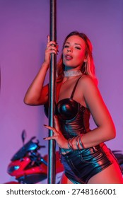 A striptease model working in a photo studio with a motorcycle and posing beautifully