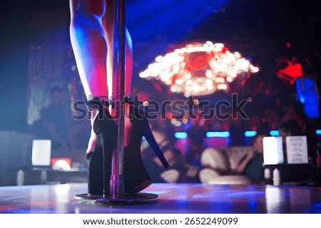 Striptease Performance with High Heels on Stage in Nightclub with Neon Lights