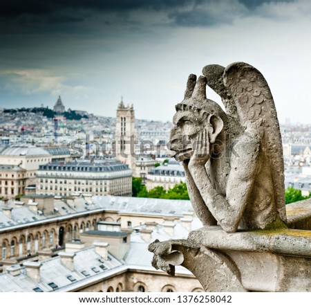 Strix (stryge) of Notre-Dame Cathedral and view of Paris. France