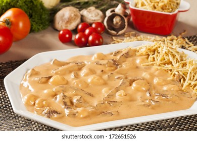 stroganoff with fries on a table.