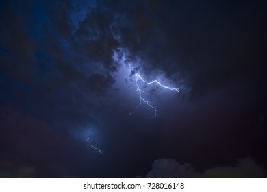 Stroke of lightning with storm clouds