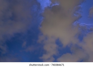 Stroke of lightning with storm clouds