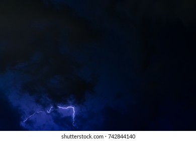 Stroke of lightning with storm clouds