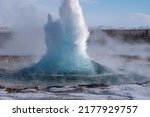 Strokkur geyser in Iceland erupting, shot during winter with nobody around 