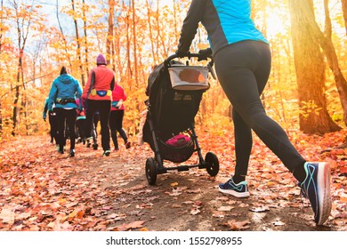 Stroller woman group out running together in an autumn park they run a race or train in a healthy outdoors lifestyle concept