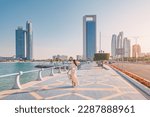 Strolling along the Abu Dhabi Corniche, a scenic waterfront promenade with stunning views of the Arabian Gulf and the city