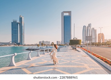 Strolling along the Abu Dhabi Corniche, a scenic waterfront promenade with stunning views of the Arabian Gulf and the city's iconic skyscrapers, is a must-do for any visitor to the UAE's capital. - Powered by Shutterstock