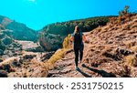 Strolling along the spectacular Calomarde Footbridges, a girl enjoys the Sierra de Albarracín, where mountains, water and trails come together in a fascinating landscape of Teruel.