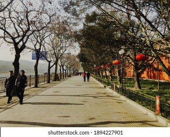 Strolling On An Alley Way In China Near A Lake