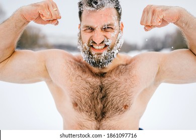 Strong Aggressive Brutal Naked Man With Frozen Beard Showing Muscules Outdoors