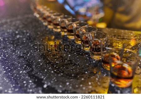 Strong alcohol drinks, hard liquors, spirits and distillates iset in glasses: cognac, scotch, whiskey and other