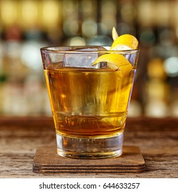 A Strong Alcoholic Cocktail In A Glass Of Old Fashion Is On The Bar In The Restaurant. Space For Text
