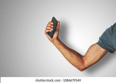 Strong Arm Holding A Smart Phone