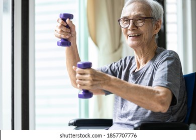 Strong asian senior woman working out with heavy dumbbells,lifting dumbbell weights for strength training,fitness elderly people doing exercise while sit in wheelchair,health care,healthy lifestyle - Powered by Shutterstock