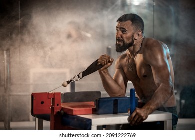 Strong Athlete In The Gym Training For Arm Wrestling Sparring. Bodybuilder Armwresler In Athletic Training Room