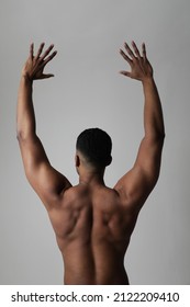 Strong Athletic Black Man Shows Naked Muscular Body. Back View. Vertical.