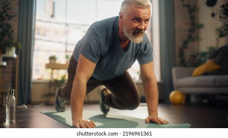 Strong Athletic Fit Middle Aged Man Doing Mountain Climber Exercises During Morning Workout at Home in Bright Apartment. Healthy Lifestyle, Fitness, Recreation, Wellbeing and Retirement. - Powered by Shutterstock